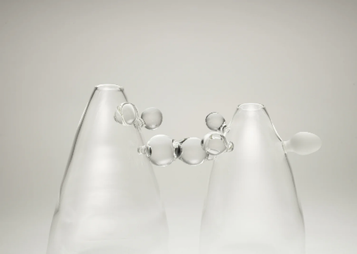 Minimalist glass sculpture with frosted surfaces and bubble-like transparent forms